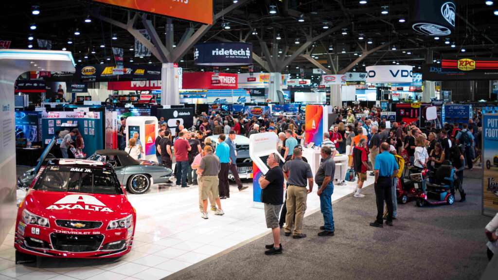 A car show at a convention centre filled with people